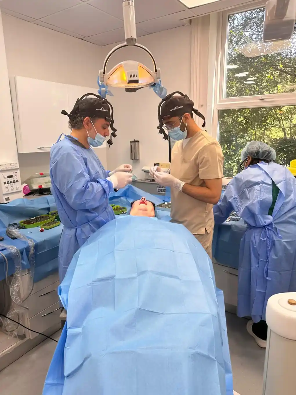 Surgical team performing a dental implant procedure in clinic