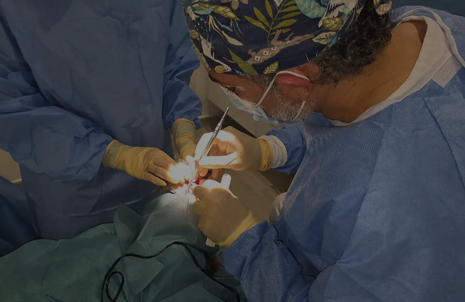 Surgeon performing skin cancer excision surgery in theatre